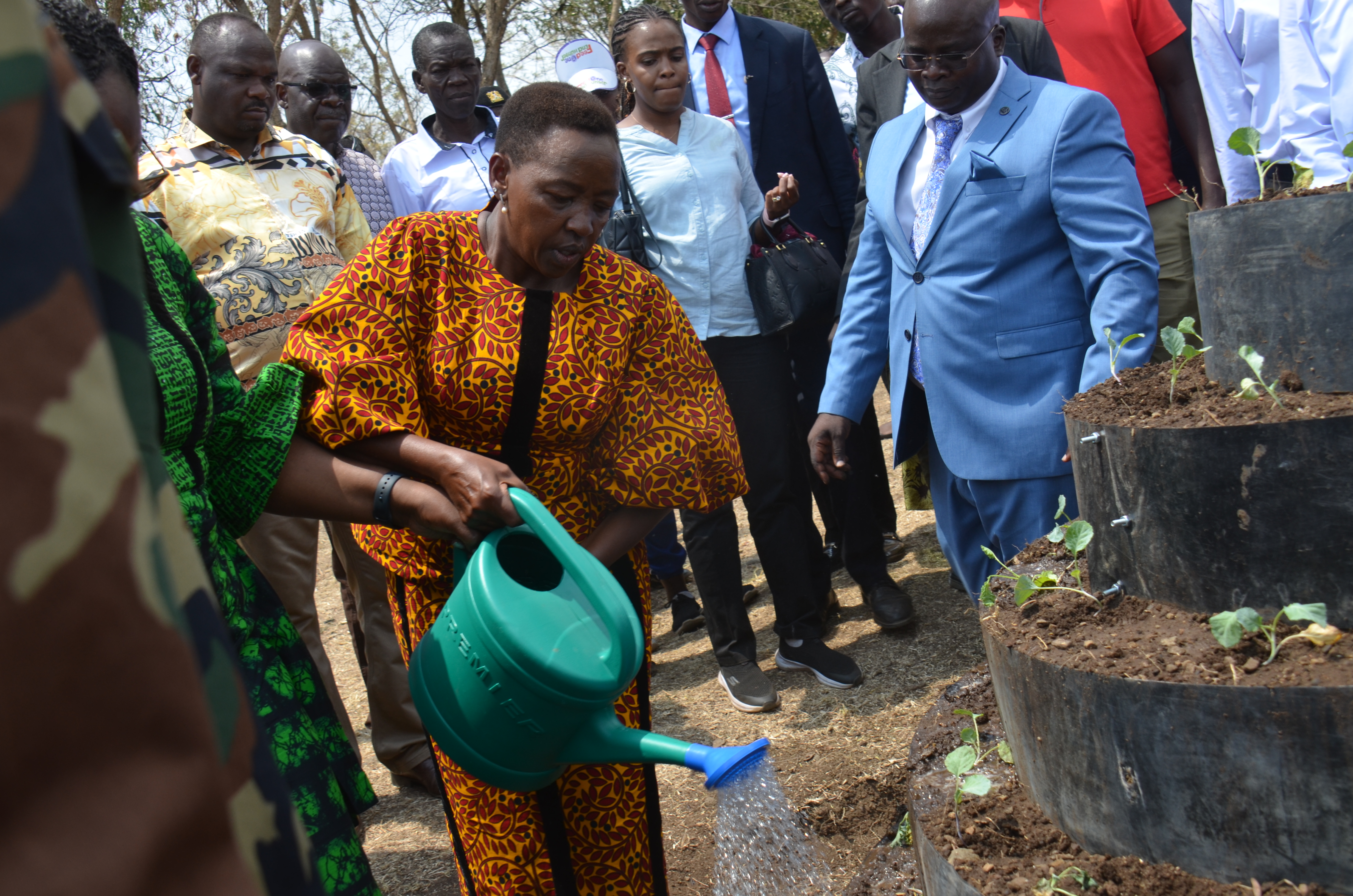 The First Lady Mama Rachel Ruto watering a kitchen garden at Bondo Kosiemo Primary school in Nyatike West Sub County. Photo/MAKOKHA KHAOYA