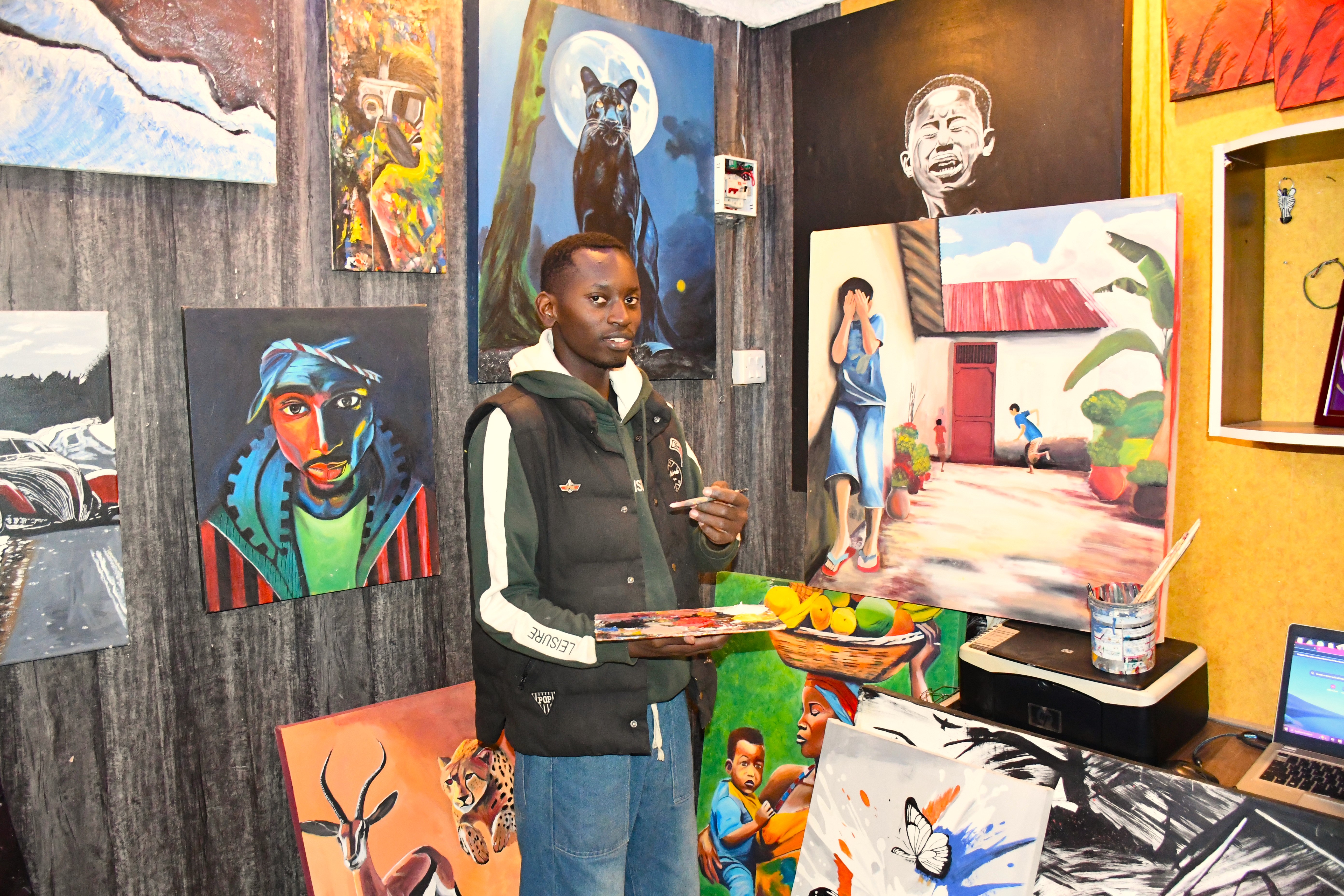 Kericho-based artist Jorim Muinda, aged 30 showcasing the colorful, handcrafted masterpieces at his shop in Simba Gate Mall, Kericho Town