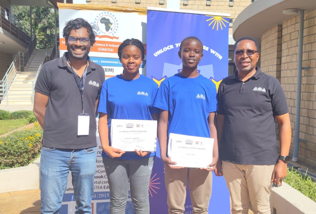 Co-founder and Executive Director of the African Olympiad Academy, Arun Shanmuganathan (L); Mitchelle Ombuna, successful student (2nd left); Caleb Tanui, successful student (2nd right); and National Trainer and Coordinator of the STEM Boot Camp at CEMASTEA, Mr. Martin Mungai (R), pose for a photo during the closing ceremony of the 2026 African Olympiad Academy (AOA) Rising Stars Training Camp at Karen Campus, Nairobi.