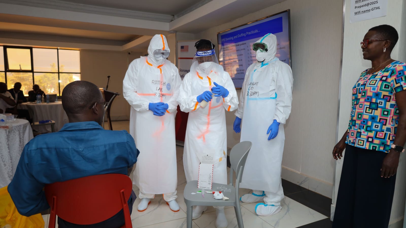 Kenya National Public Health Institute (KNPHI) staff demonstrating PPE donning and doffing practical training session