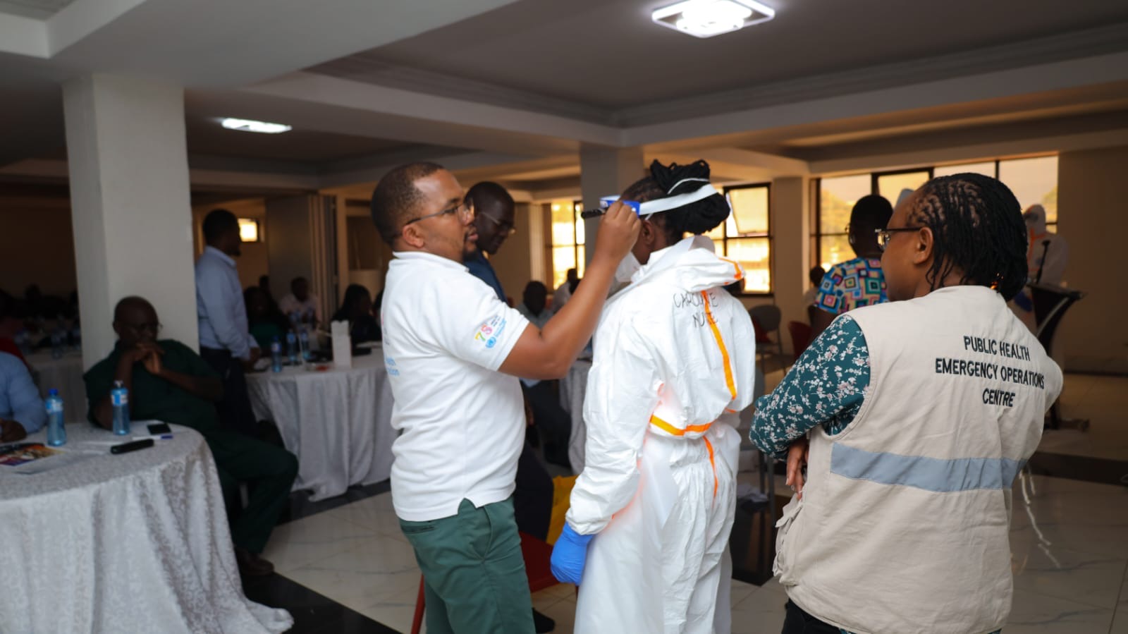 Kenya National Public Health Institute (KNPHI) staff demonstrating PPE donning and doffing practical training session