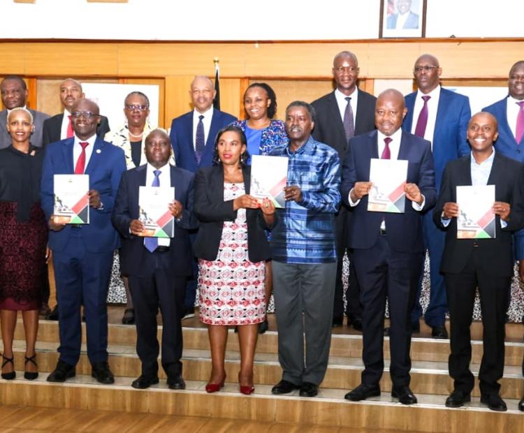 he Cabinet Secretary, Ministry of Information, Communications and the Digital Economy (MICDE), Dr. Margaret Ndung’u (fifth left) flanked by ICT and Digital Economy Principal Secretary Eng. John Tanui , Sector Working Group (SWG) Chairperson Prof. Timothy Waema (right) and the Principal Secretary for Broadcasting and Telecommunications Prof. Edward Kisiang’ani during the handover ceremony of the ICT SWG Final Report. Photo by Beverlyne Musili.