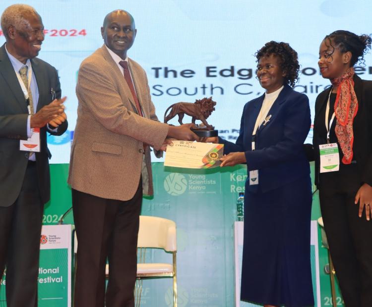 Prof. Mary Abukutsa-Onyango (second right) receives her award from the Kenya National Research Fund CEO, Prof. Dickson Andala as Prof Ratemo Michieka (left) looks on.