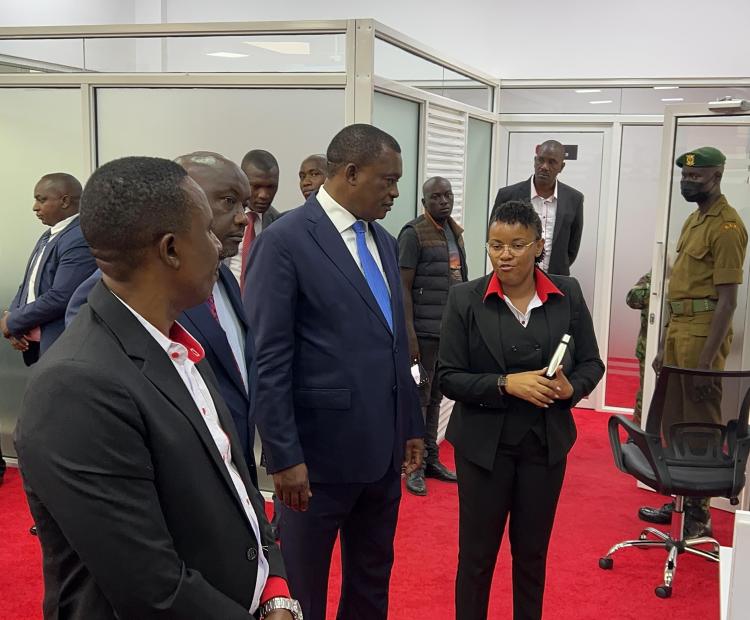 Cabinet Secretary (CS) for Public Service and Human Capital Development Hon. Justin Muturi (Centre) consults with a Huduma center staff during his inaugural visit to Huduma Kenya Secretariat Offices, Huduma Contact and Tele-Counselling Centre and Huduma Centre GPO in Nairobi.