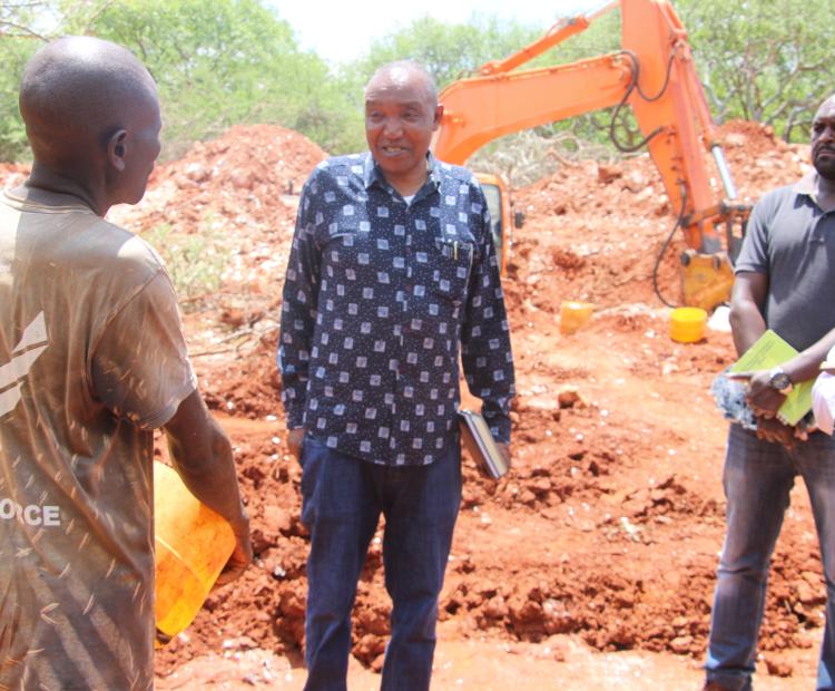Director mines, Gregory Kituku (in checked shirt) talking to miners of mica belonging to Apple Mining Group in Kishushe. 