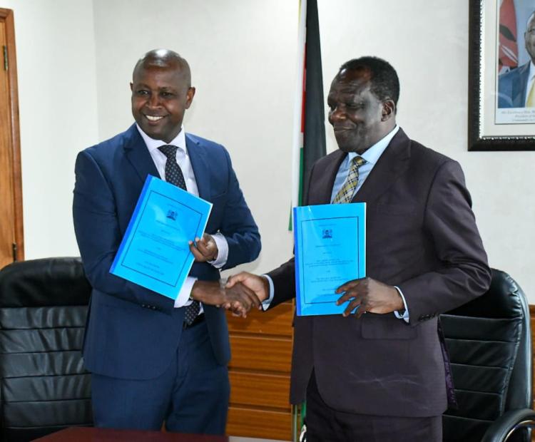 Ministry of Co-operatives and MSMEs Development Cabinet Secretary, Dr. Wycliffe Oparanya with Principal Secretary for Co-operatives, Patrick Kilemi shake hands holding the FY 2024/2025 Performance Contract for the Cooperatives Department after the signing. 