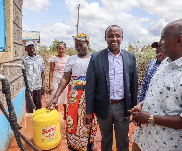 Governor Mutula (Left) and ASAL PS Harsama (right) at Kioski 1 at Yikitaa market where residents are able to access clean water for domestic use and watering of their animals