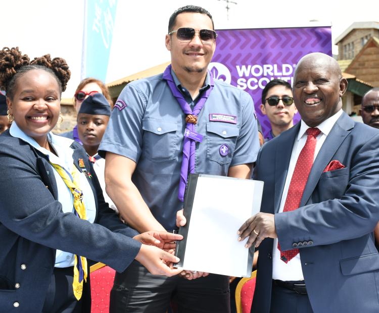 World Scouts and Guides Board assistant chairperson,  Josephine Mwangi, Daniël Corsen, chairperson of World  Scout committee (centre) presents a declaration desig nating Nyeri County as the official global scouting city  of the world to Nyeri Governor Dr. Mutahi Kahiga 