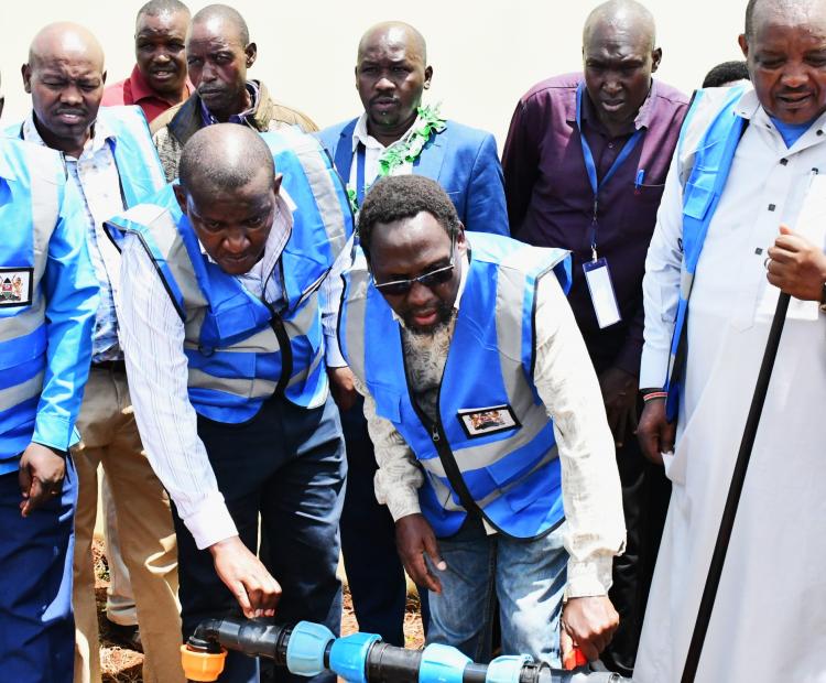  PS Irrigation Ephantus Kimotho (seond right) turns on water to commission a new Micro Irrigation for Schools project in Barwessa, Baringo County. Photo/Christopher Kiprop