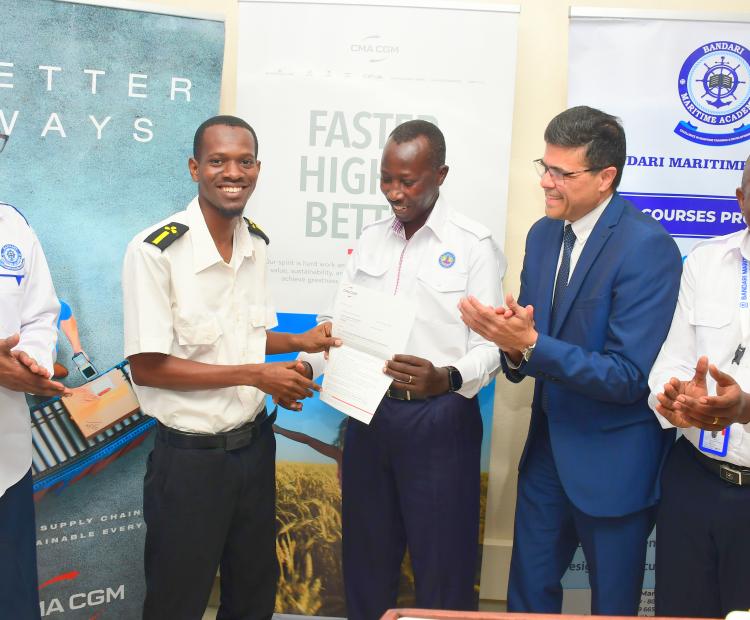 Bandari Maritime Academy (BMA) Chief Executive Officer (CEO) Dr. Eric Katana leads (R), CMA CGM Managing Director (MD) Naveen Prabhu (Second R) and BMA staff hand over an appointment letter to Kumbo Hamadi (Second L) during the sendoff ceremony of cadets for shipboard training with global shipping line CMA CGM at BMA Headquarters. 