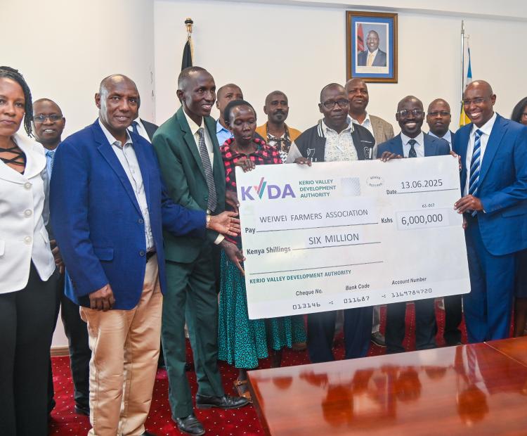  PS State Department for ASALs and Regional Development Kello Harsama handing over  the cheque of 60M to Weiwei Farmers. 