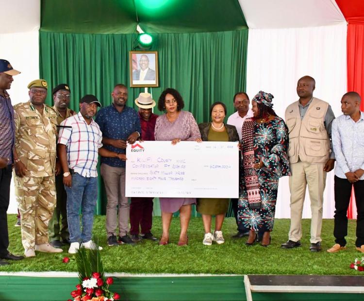 Leaders display a dummy cheque of Sh60,384 million. Tourism and Wildlife Cabinet Secretary, Rebecca Miano, handed over actual cheques to 24 families of victims of human-wildlife conflicts between 2014 and 2020.