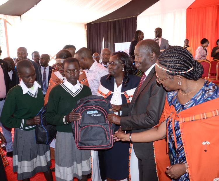 Cabinet Secretary (CS) for Gender, Culture and Children’s Services Hanna Cheptumo handing over a dignity kit with Baringo Governor Benjamin Cheboi to Junior Secondary School students during a ceremony held at Kabarnet School for deafblind.