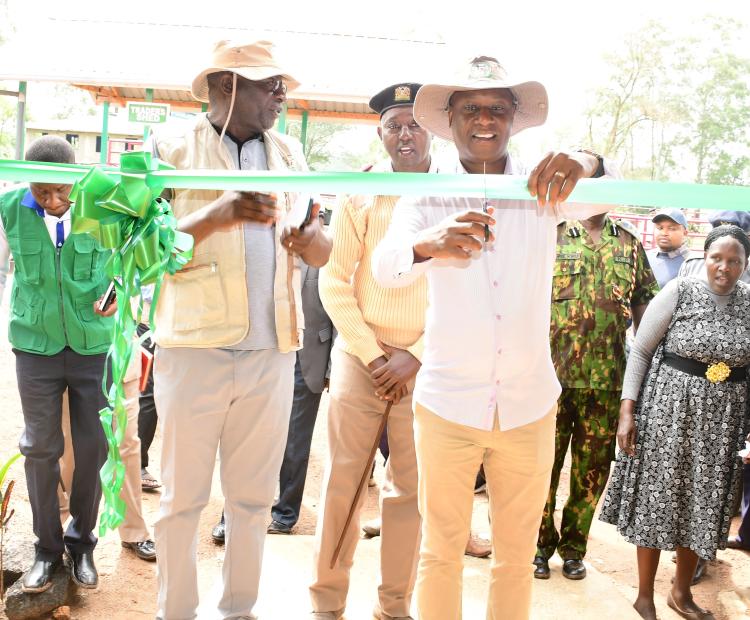 PS livestock production Jonathan Mueke cutting the ribbon as he officially opens Nambale livestock sale yard in Nambale Sub County, Busia County 