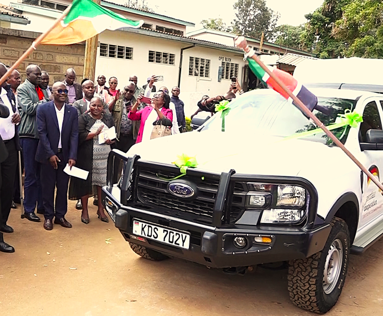 Embu Deputy Governor Kinyua Mugo (left) flags off two double cab pickups donated to the County by German Cooperation for the new rehabilitation center at Runyenjes Level Four Hospital.