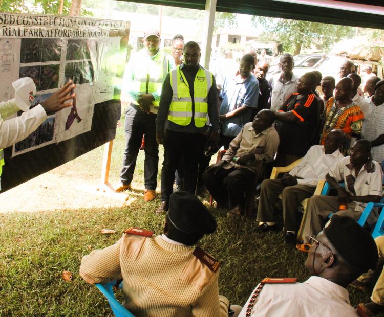 Residents of Nasewa, being taken through the architectural plan of the Nasewa industrial park housing project.