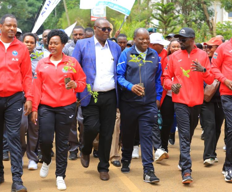 Staff from various water companies participate in a walk during the opening ceremony of the Water Companies Sports Organization (WASCO) games at Gusii Stadium in Kisii. 