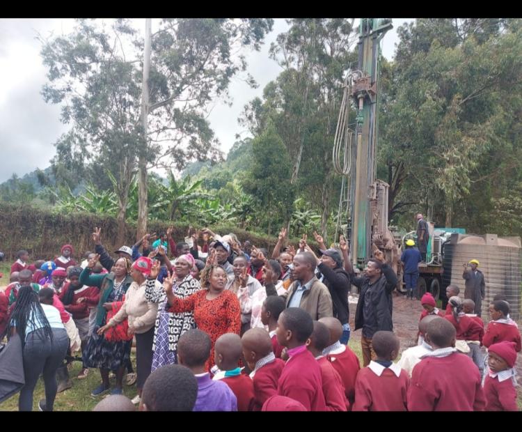 Igembe North residents celebrate the drilling of a borehole at Mwerongundu Primary School grounds. PHOTO: LENAH KANARIO 
