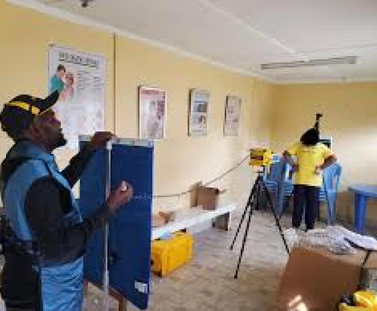 A health technician conducting TB screening using modern diagnostic equipment  at a public facility in Kenya.