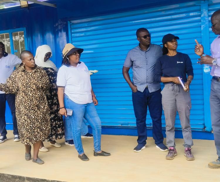 Vihiga County Project Coordinator Wilson Munala (23rd from Right) briefs stakeholders on the fish processing kiosk during a site visit at Kaimosi Vocational Training Centre.