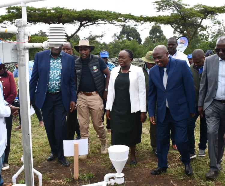 A Meteorologist (left) explains how a set of rain gauges work to Cabinet Secretary (CS) for Environment, Climate Change and other dignitaries during celebrations to mark the World Meteorological Day in Njoro, Nakuru County.
