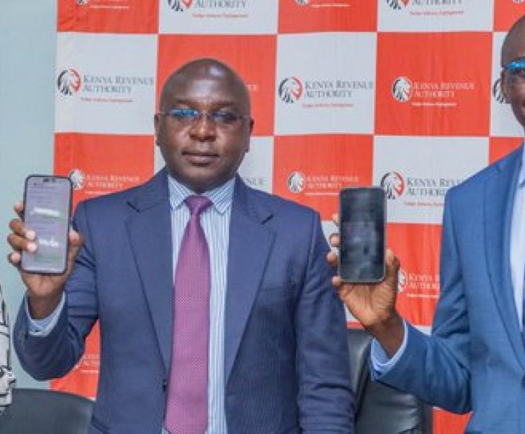 Kenya Revenue Authority (KRA) Commissioner General Humphrey Wattanga (Center) during the launch of the WhatsApp-based tax filing solution.