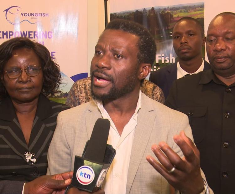 The Aquaculture consortium CEO Mr. Felix Osok addressing the media during the launch of youth led initiatives to bridge fish deficit in the country. He is flanked by Kisumu County Education Director Rosemary Birenge and Blue Economy regional coordinator Samson Kidera.