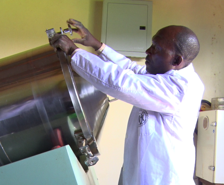 A Kenya Industrial Research Development Institute (KIRDI) official opens a mixer at the Migori KIRDI office. The mixer is used by scale farmers for mixing feed ingredients for animals, poultry and fish. Photo by Makokha Khaoya.