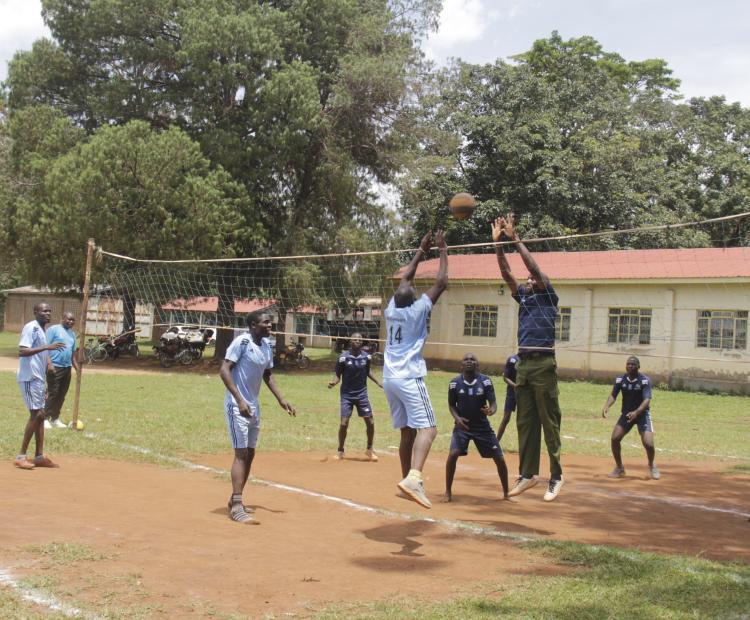 Members of the public, police ,NGAO officers and officers from Security Research and Information Centre walks with a banner advocating for peace building to enhance security.
