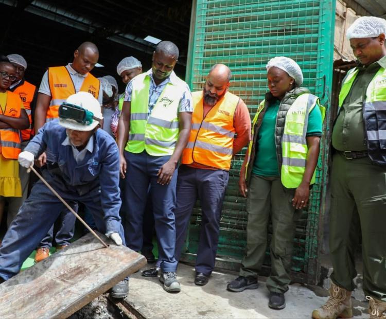 Cabinet Secretary for Environment, Dr Deborah Barasa (2nd right), Dr Mamo B Mamo NEMA Director General (far right) with staff of Canon Chemicals who manufacture soap and beauty products in Mlolongo during an inspection tour of effluent discharges into Nairobi Rivers. PHOTO: ANNE KANGERO