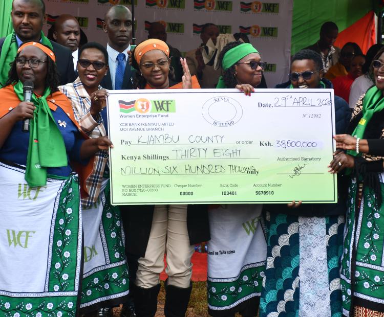 Gender CS Hanna Cheptumo presents a cheque worth Sh38.6 million to representatives of women groups at the Kiambu Women Empowerment Forum.
