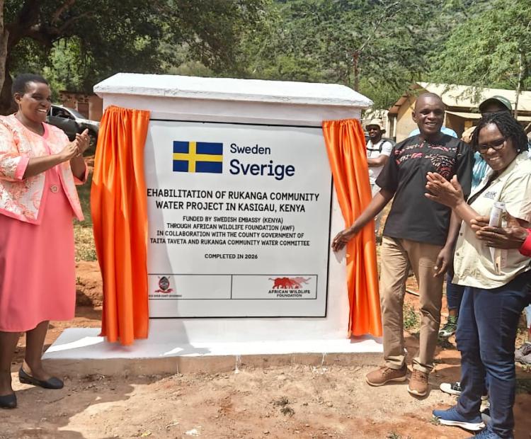 Taita Taveta County Deputy Governor Christine Kilalo (Left) claps after commissioning of the Rukanga Sh4.6 million water project at Kasigau, Taita Taveta.