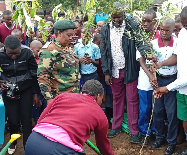 Homa Bay County Chief Conservator, Sharon Cheluget (second left), Commissioner Eli Kisulu, Tree Ambassador and Nuhu Omollo Masoud, Patron, Plant trees for a better Environment CBO during a tree planting initiative at Lake Primary School in Homa Bay town.