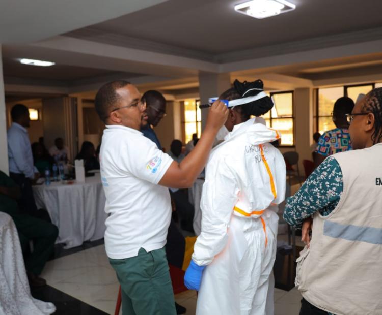 Kenya National Public Health Institute (KNPHI) staff demonstrating PPE donning and doffing practical training session