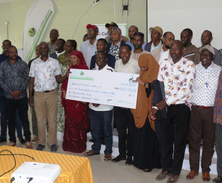 Presentation of a dummy cheque for pastoralist communities from four counties in northern Kenya who have received Sh 655 million in carbon credit earnings under a community-led rangeland conservation programme