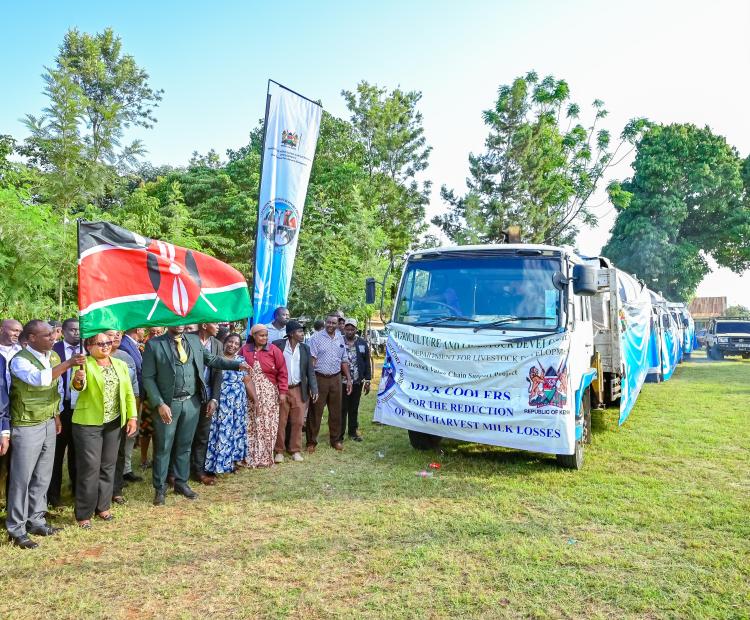 Principal Secretary for Livestock Development Jonathan Mueke (second left) and Kirinyaga County Governor Anne Waiguru (third left) flag off one of the 13 bulk milk coolers during the handover ceremony in Gichugu, Kirinyaga County.