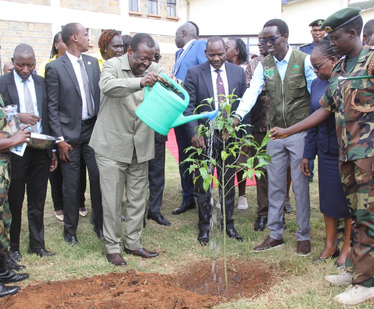 Prime Cabinet Secretary and Cabinet Secretary for Foreign and Diaspora Affairs Musalia Mudavadi plants a tree seedling during the official launch of the Integrated Natural Resources Management Programme (INReMP) at the University of Eldoret in Uasin Gishu County