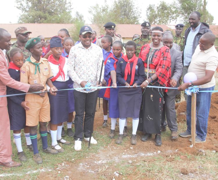 Defence PS Patrick Mariru (with cap) and Laikipia North Member of Parliament Sarah Korere (Second Right) cutting a ribbon for the commencement of dormitory construction in Ngenia Comprehensive School.