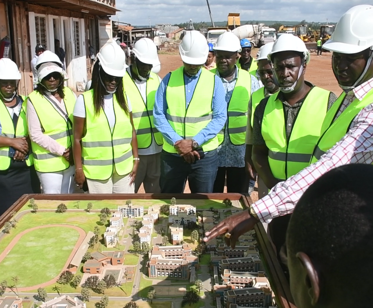 Prof. Julius Bitok  accompanied by Kilfi County  Governor Gideon Mung’aro  and other stakeholders  viewing a 3D plan of the  Ronald Ngala Utalii College at  Vipingo in Kilifi County. 